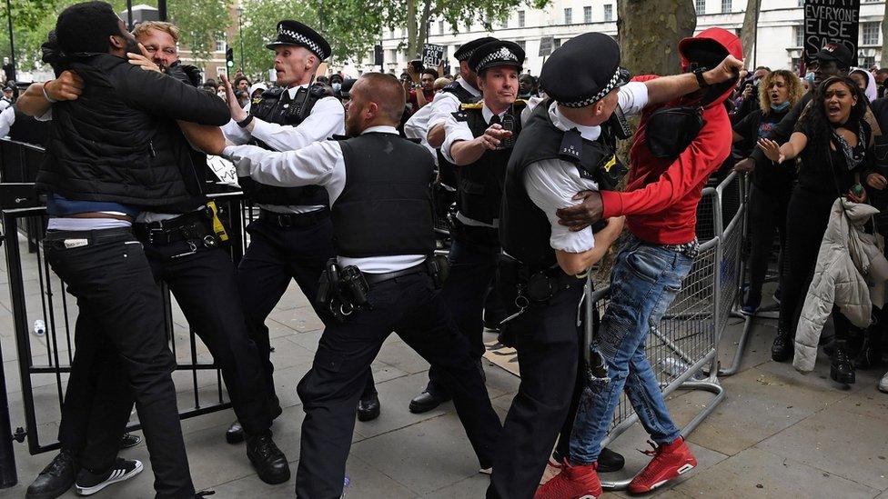 Police clash with protesters outside Downing Street