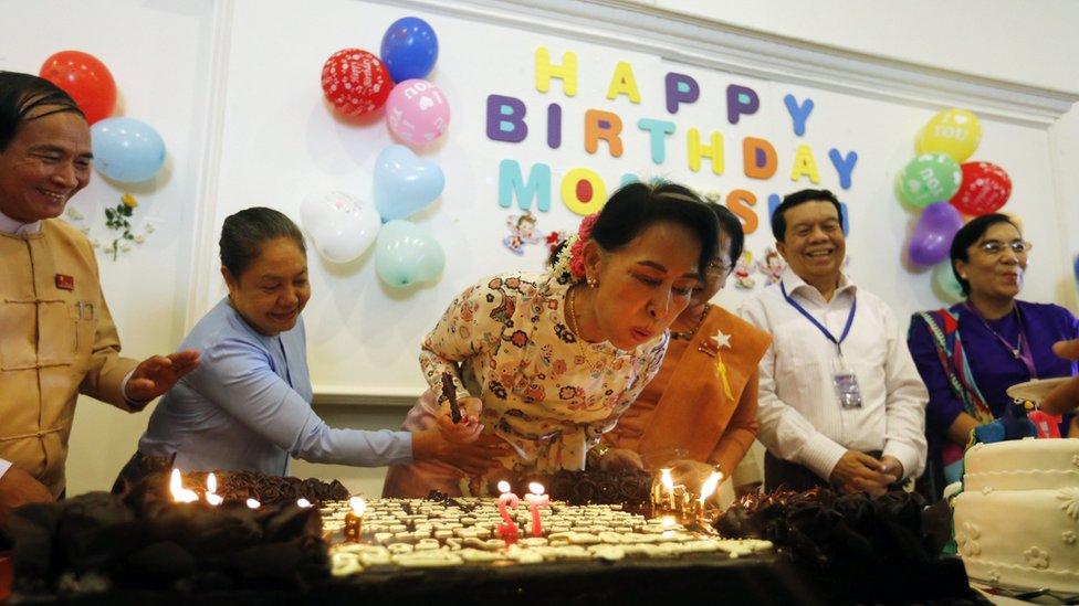 Myanmar's state counsellor Aung San Suu Kyi (C) blows on candles during a ceremony celebrating her 72nd birthday at the Parliament in Naypyitaw, Myanmar