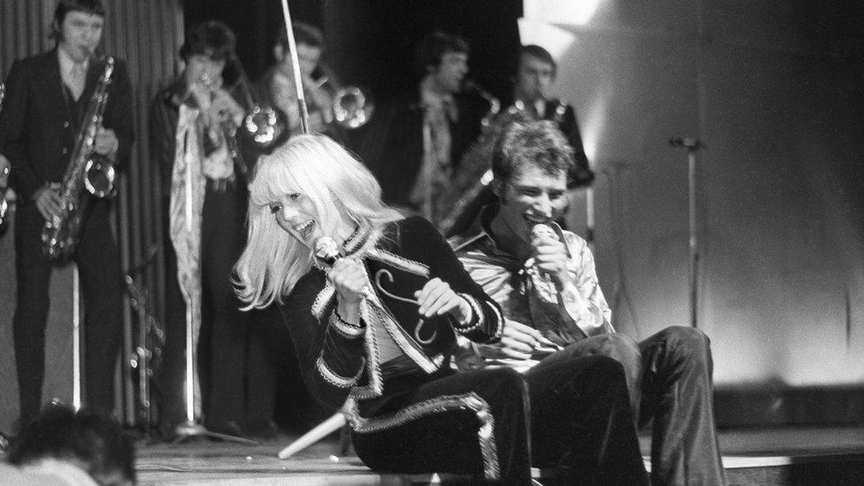 A file photograph taken on March 17, 1967 in Paris, shows Sylvie Vartan (L) and Johnny Hallyday singing as they give a concert, the profits of which are to go to cancer research, at the Olympia venue