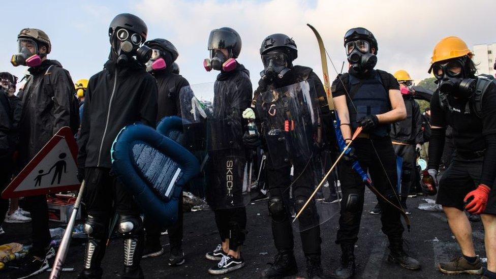 Protestors stand on a bridge in Hong Kong