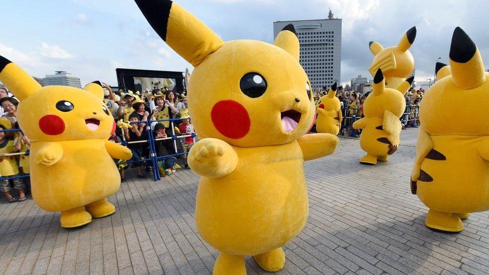 People in Pikachu costumes onstage in Japan