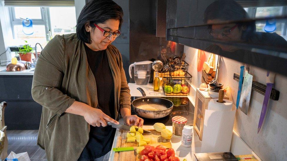 Ruchita Green in her kitchen preparing dishes for her cooking classes