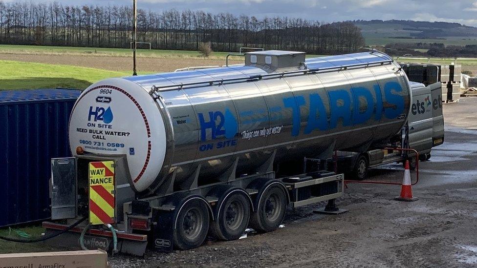 A large water tanker at Trenchard Lines, with the countryside in the background