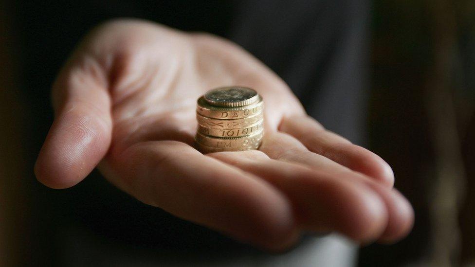 Hand with coins on