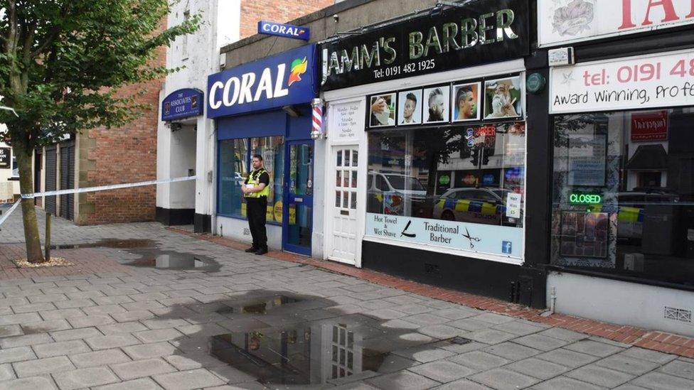 Police officer stands outside the bookmakers