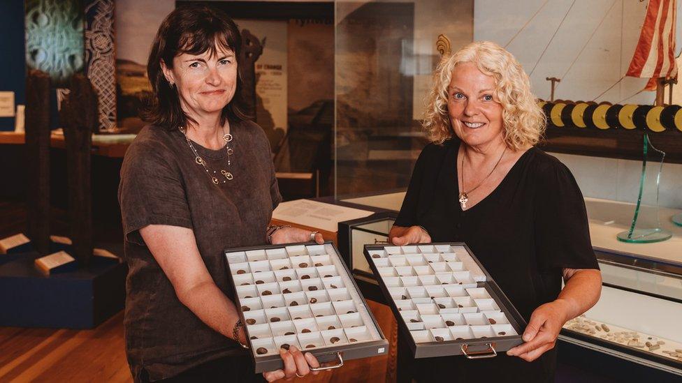 Allison Fox and Kath Giles holding the coins