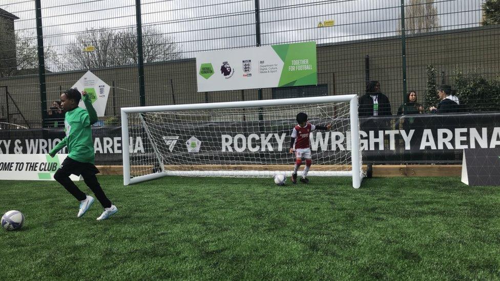 children kicking ball