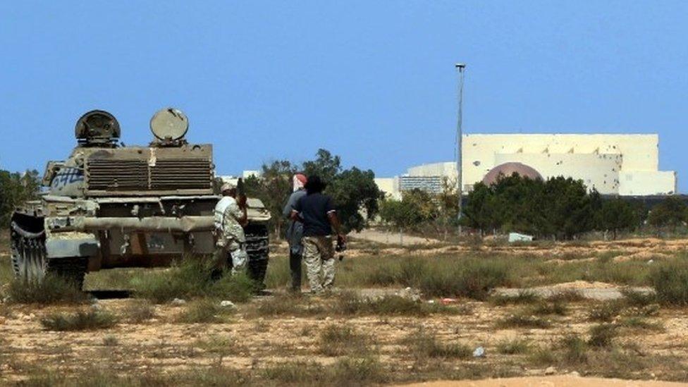 Tank and fighters with Ouagadougou centre in background