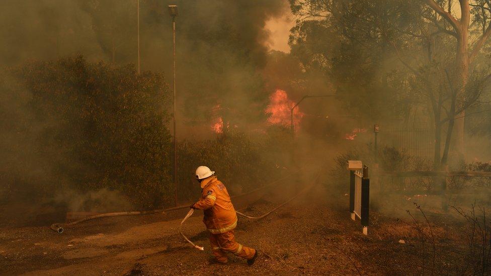 A firefighter tackles a blaze