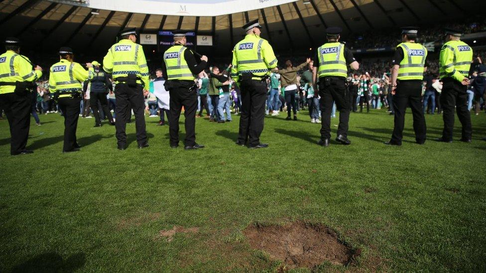 Police and fans on pitch at Hampden