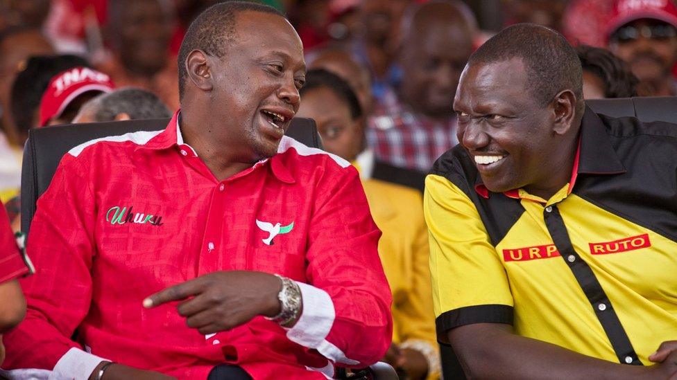 Uhuru Kenyatta (L) and William Ruto (R) talk at an election rally in Nairobi, Kenya (2 March 2013)