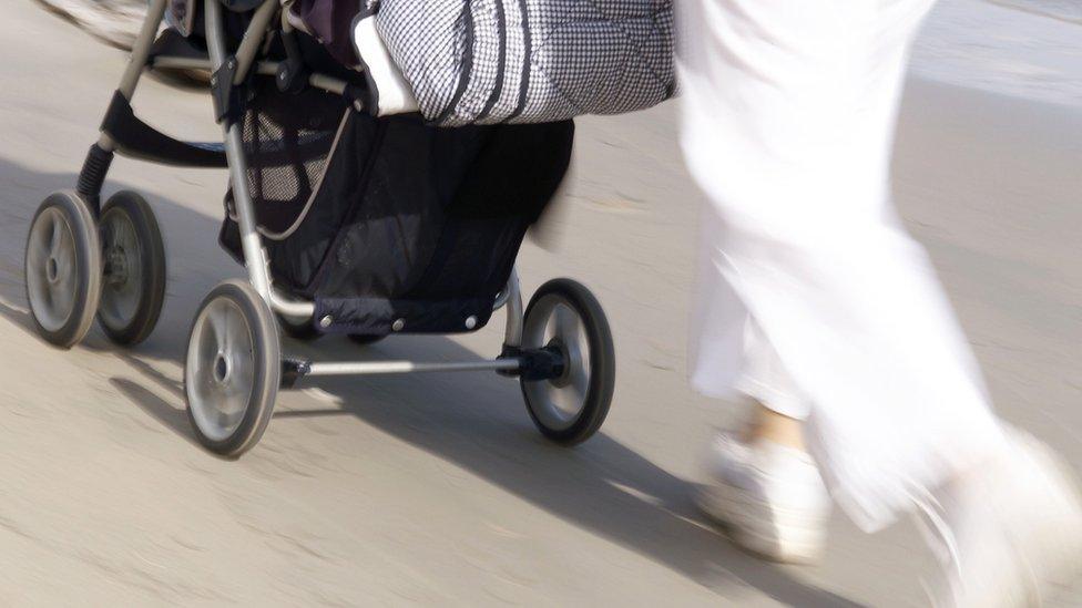 Woman pushing a buggy