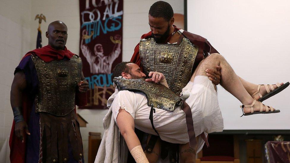 San Quentin State Prison inmates LeMar Harrison (C) and Carlos Flores (R) rperform in a production of Shakespeare's Julius Ceaser at San Quentin State Prison on May 15, 2015 in San Quentin, California.