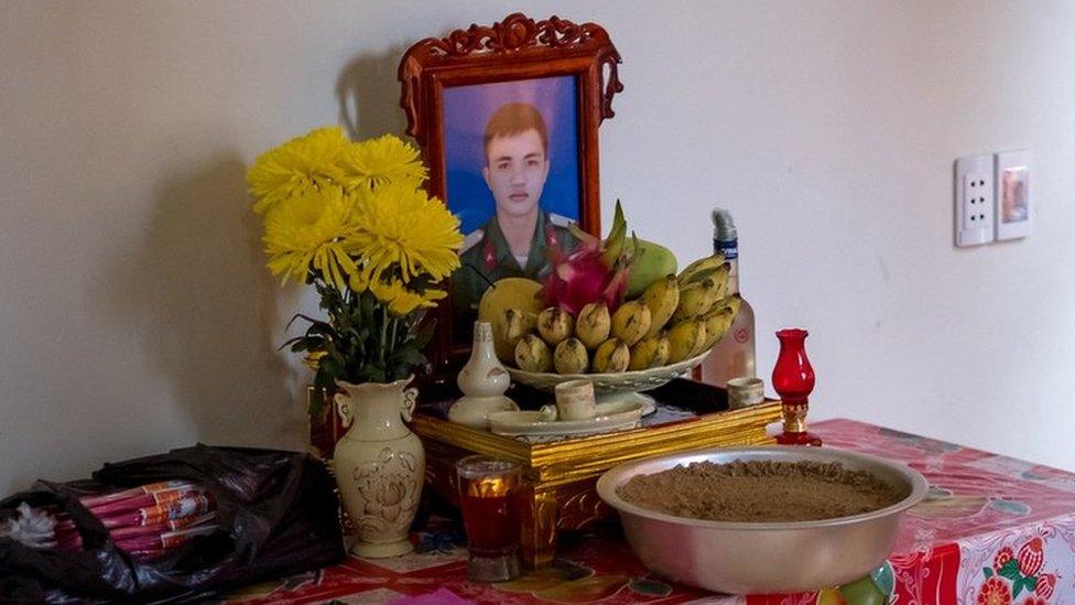 A shrine with a photo of Nguyen Dinh Tu