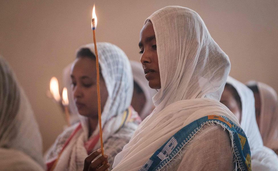 Devotees hold candles during a special service for the families of the victims of the crashed Ethiopia Airlines at Ethiopian Orthodox Church in Nairobi, Kenya, on March 17, 2019