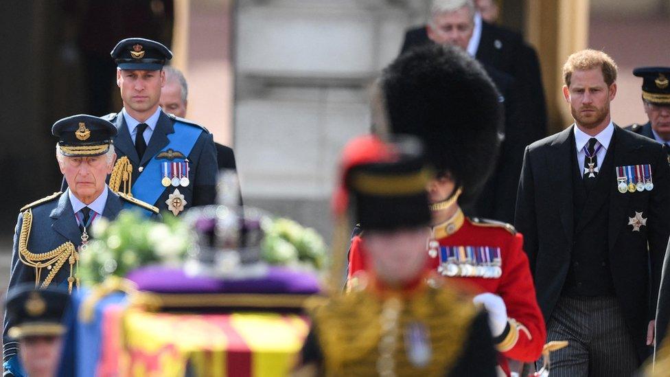 King Charles and his sons the Prince of Wales and Duke of Sussex walk behind Queen Elizabeth II's coffin