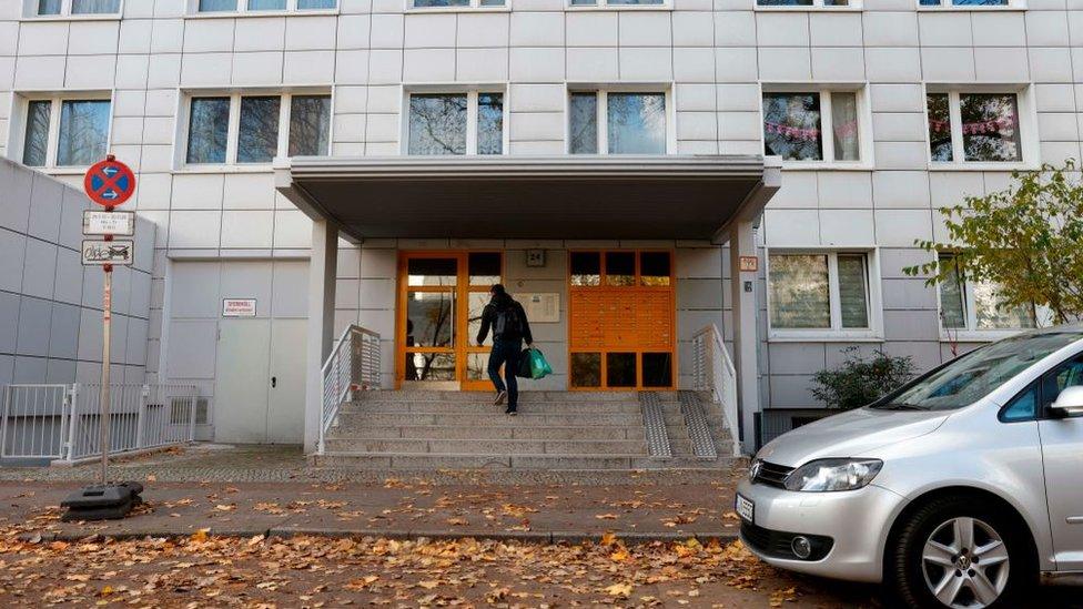 A man enters on November 20, 2020 a residential building in Berlin's Lichtenberg district, where a presumed victim of cannibalism was reported to live