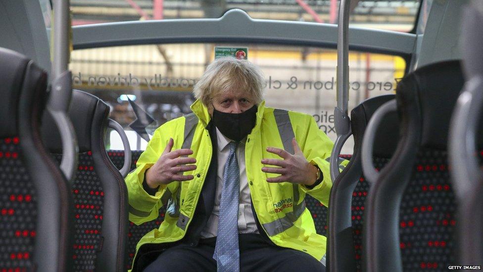 PM Boris Johnson sitting at the back of a bus in Warwickshire