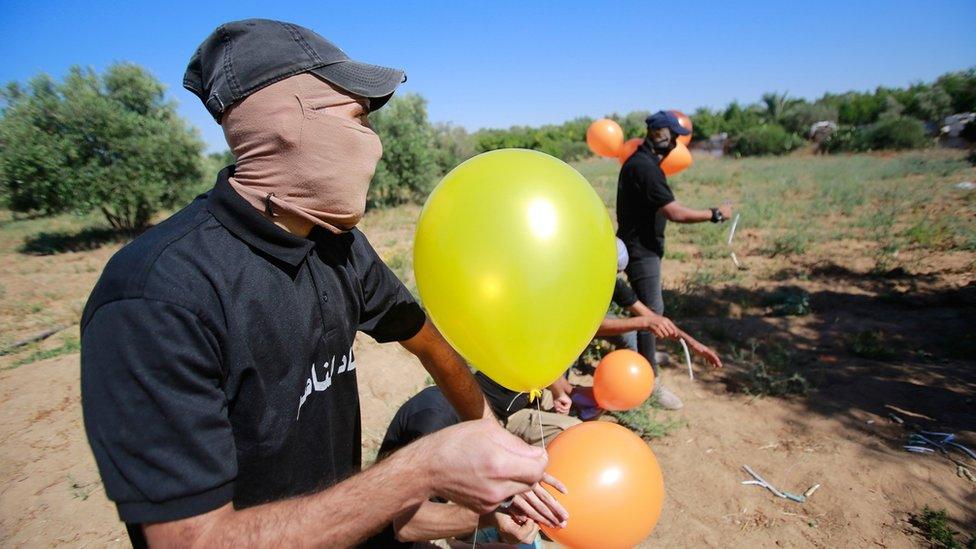 Masked Palestinians launch incendiary balloons from the Gaza Strip towards Israel (15 June 2021)