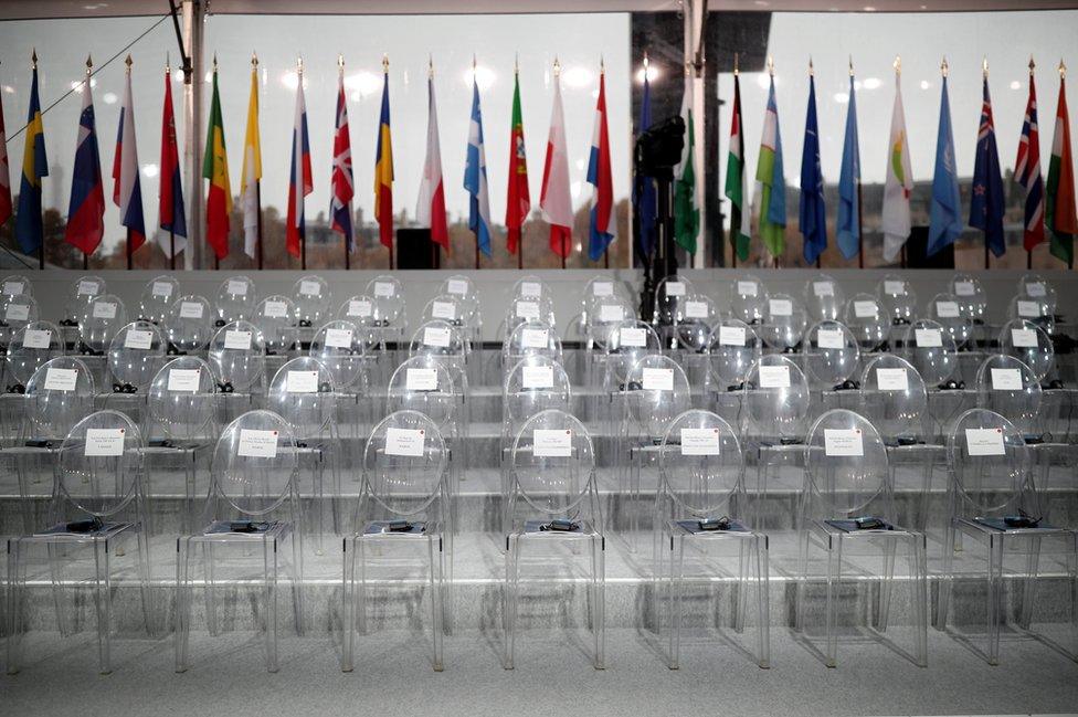 The empty chairs with the names of guests are seen before a commemoration ceremony for Armistice Day