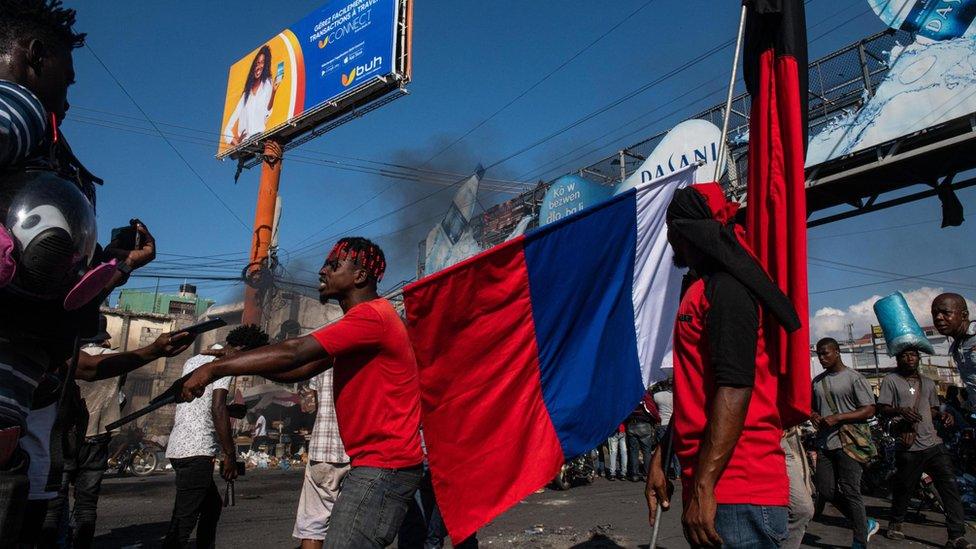 Protesters holding a flag during a demonstration