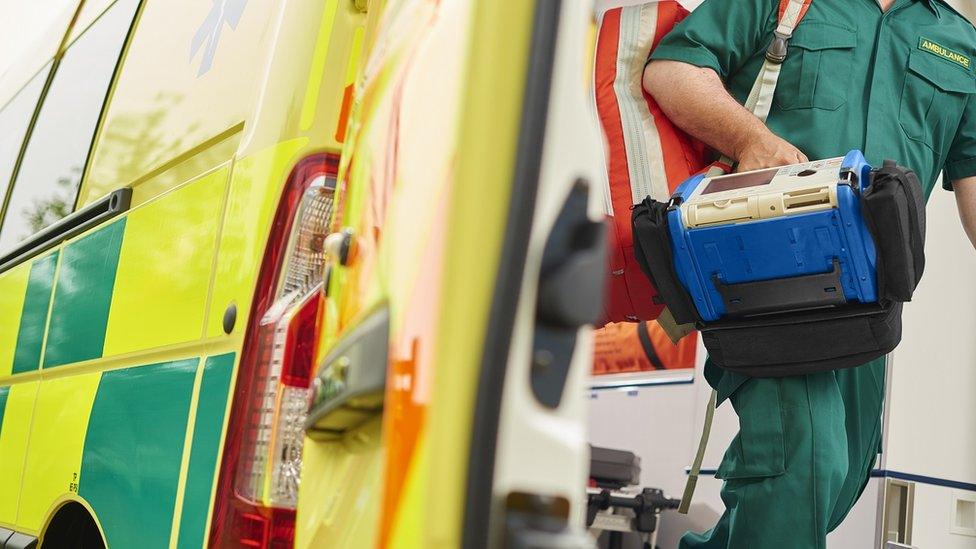 Paramedic coming out of ambulance