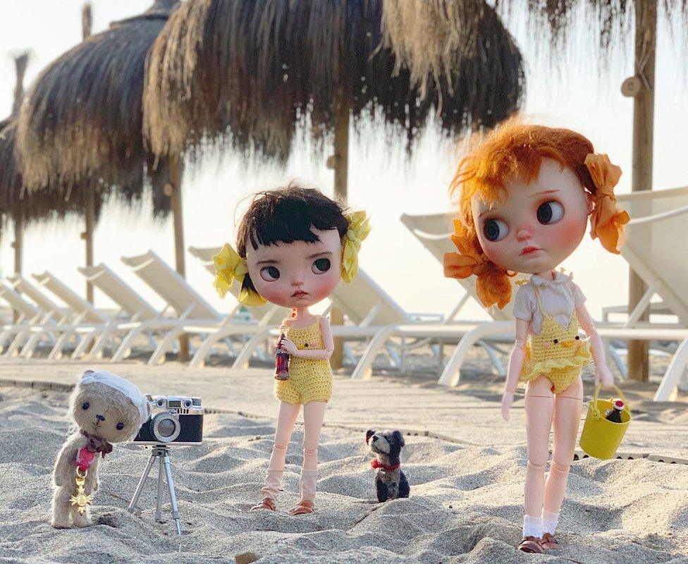 The dolls and Ted on the beach