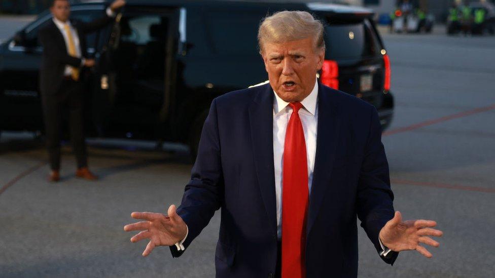 Former U.S. President Donald Trump speaks to the media at Atlanta Hartsfield-Jackson International Airport after being booked at the Fulton County jail