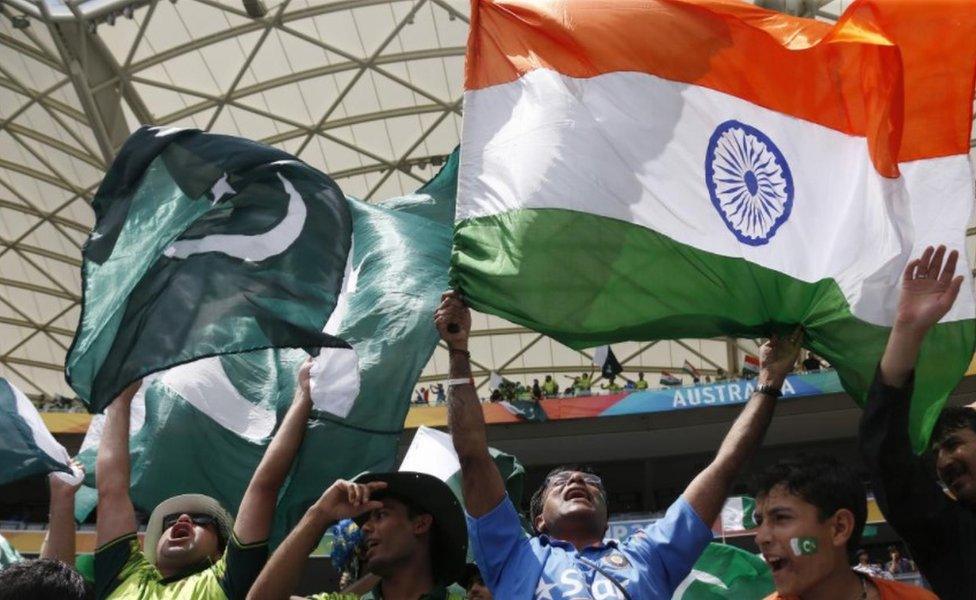 Fans of Pakistan's cricket team (L) and India's team (R) cheer in the stands before a math between the two sides at the Cricket World Cup in Adelaide, February 15, 2015.