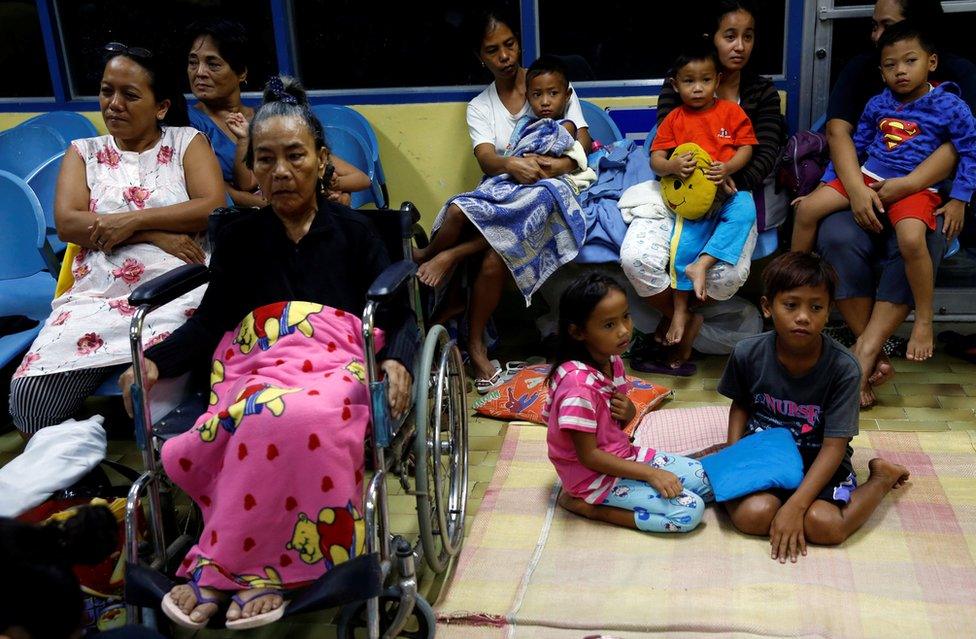 Residents who evacuated their homes due to Typhoon Haima take shelter at an evacuation centre in San Fernando, la Union in the northern Philippines on 19 October, 2016