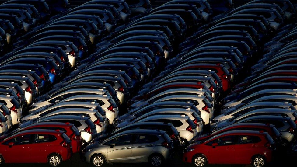 Newly manufactured cars await export at a port in Yokohama