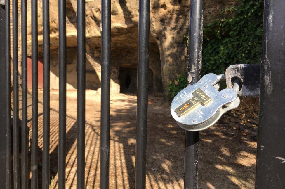 Padlock on gate to caves