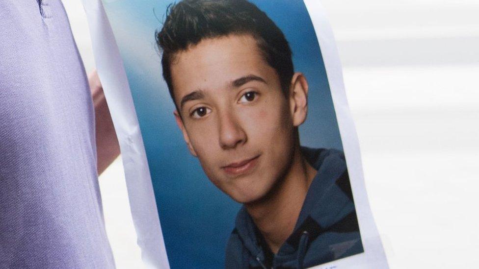 The father of Dijamant Zabergja clutches a photo of his son in Munich, 23 July