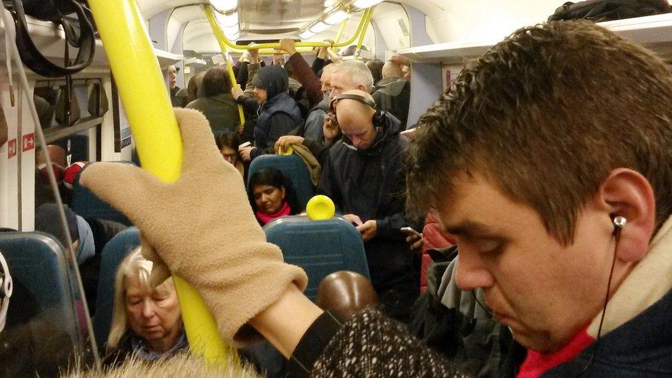 Commuters on a Southern Railway train from West Sussex to London Victoria station