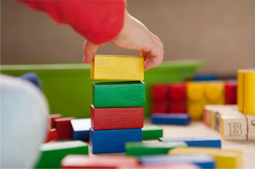 Child playing with building blocks