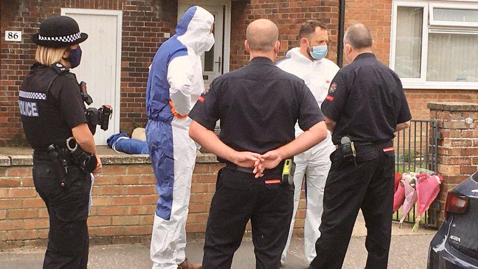 Forensic investigators outside a flat in Gorleston where a man and woman have been found dead