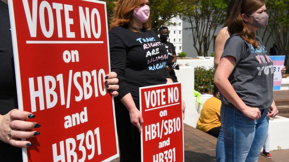 Opponents of several bills targeting transgender youth attend a rally at the Alabama State House to draw attention to anti-transgender legislation introduced in Alabama on March 30, 2021 in Montgomery, Alabama