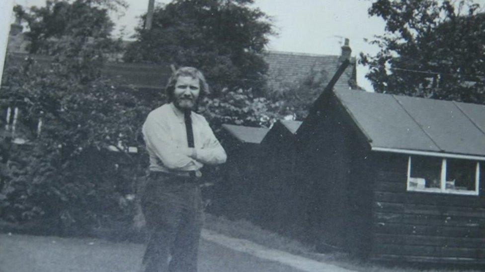 Kip Bertram next to one of the sheds where he started Bertram Books