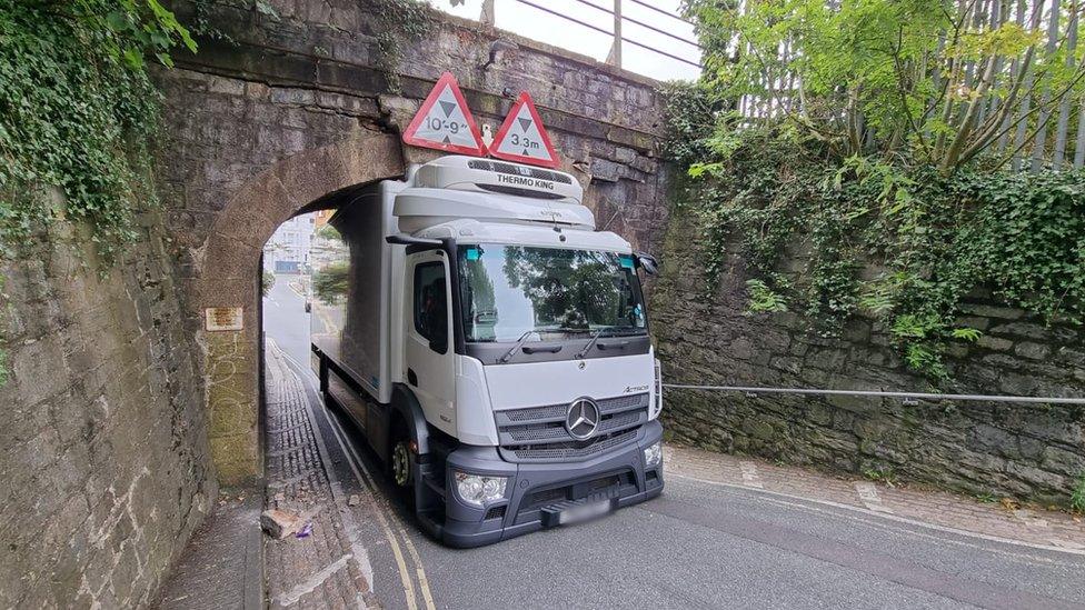 Lorry stuck under bridge