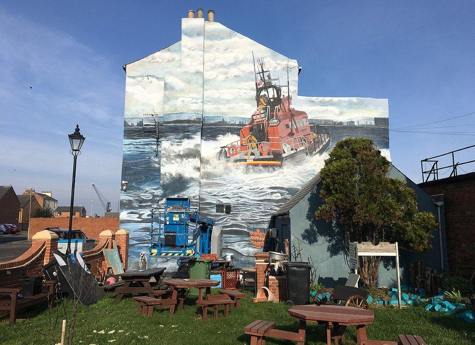 The beer garden with the mural behind