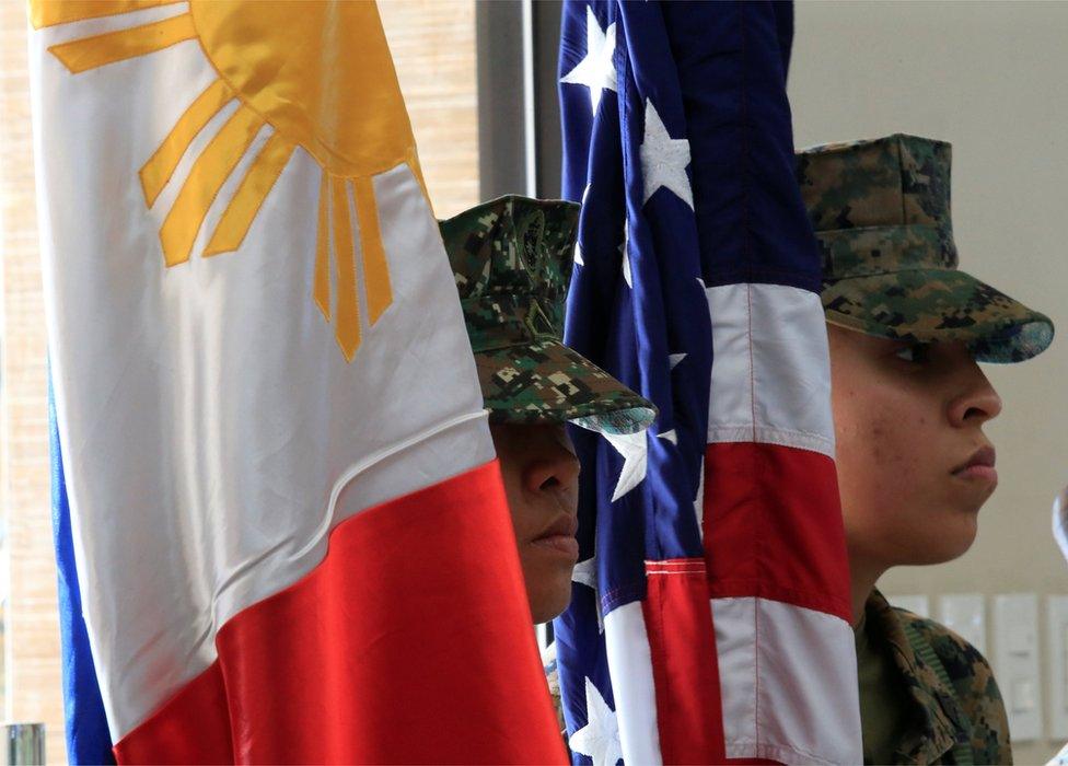 Members of the Philippine-US marine corps stand at attention with the Philippine and American flags during the Philippines-US amphibious landing exercise (PHIBLEX) closing ceremony inside the Philippine Marines headquarters in Taguig city, metro Manila, Philippines 11 October 2016