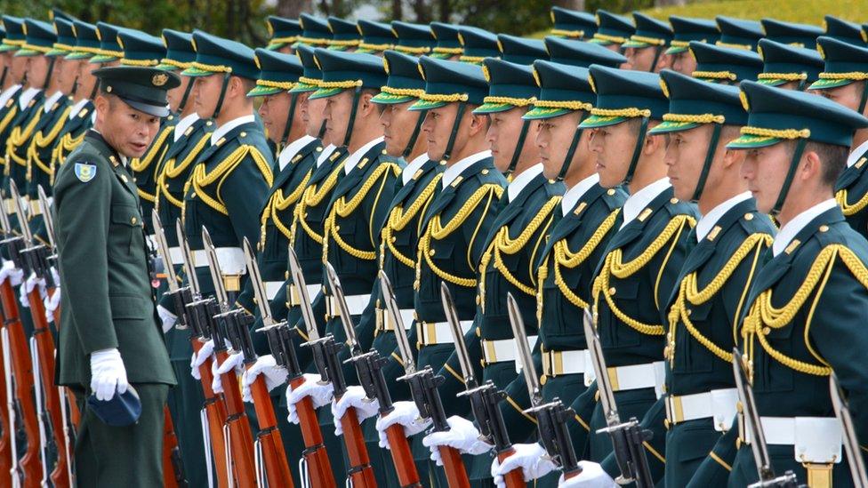 Members of Japan's self-defence Force welcome new Defence Minister Gen Nakatani in Tokyo on December 25, 2014.