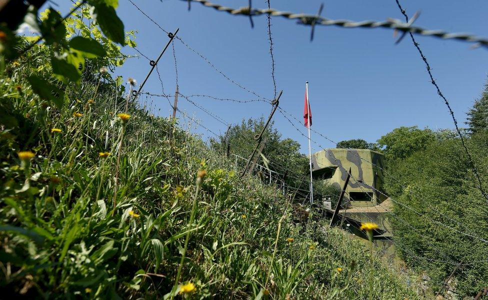 Barbed wire protects a bunker at former Swiss artillery fortress Reuenthal