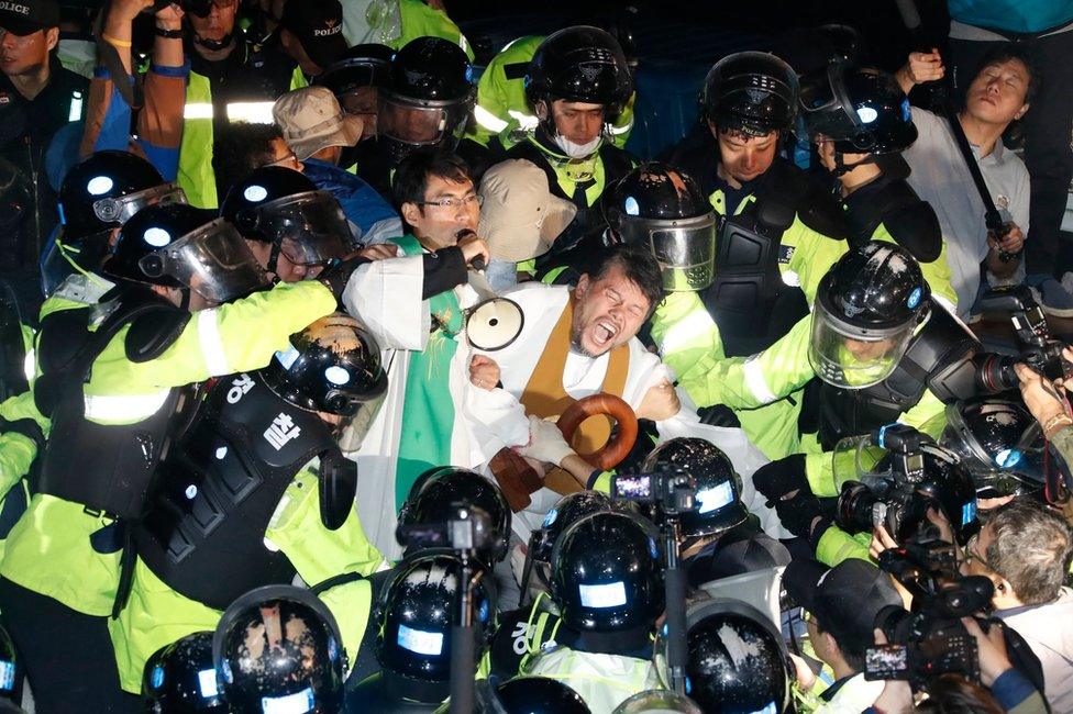 Residents and members of civic and religious groups battle riot police who try to break up their protest against the further deployment of a US missile defence system in Seongju, some 300 kilometers south of Seoul, South Korea, 7 September 2017.