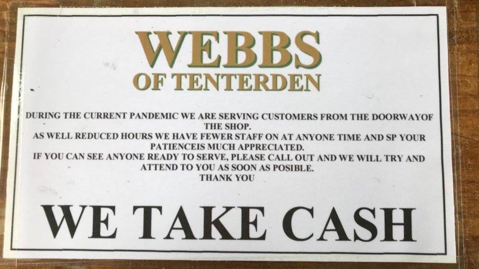 Sign at Webb's saying they take cash