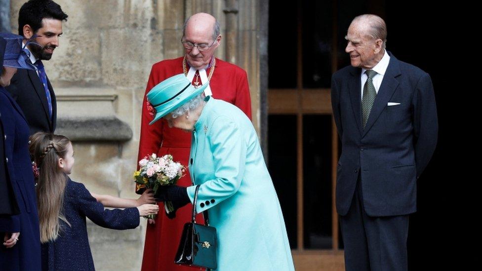 The Queen receives some flowers from a young girl