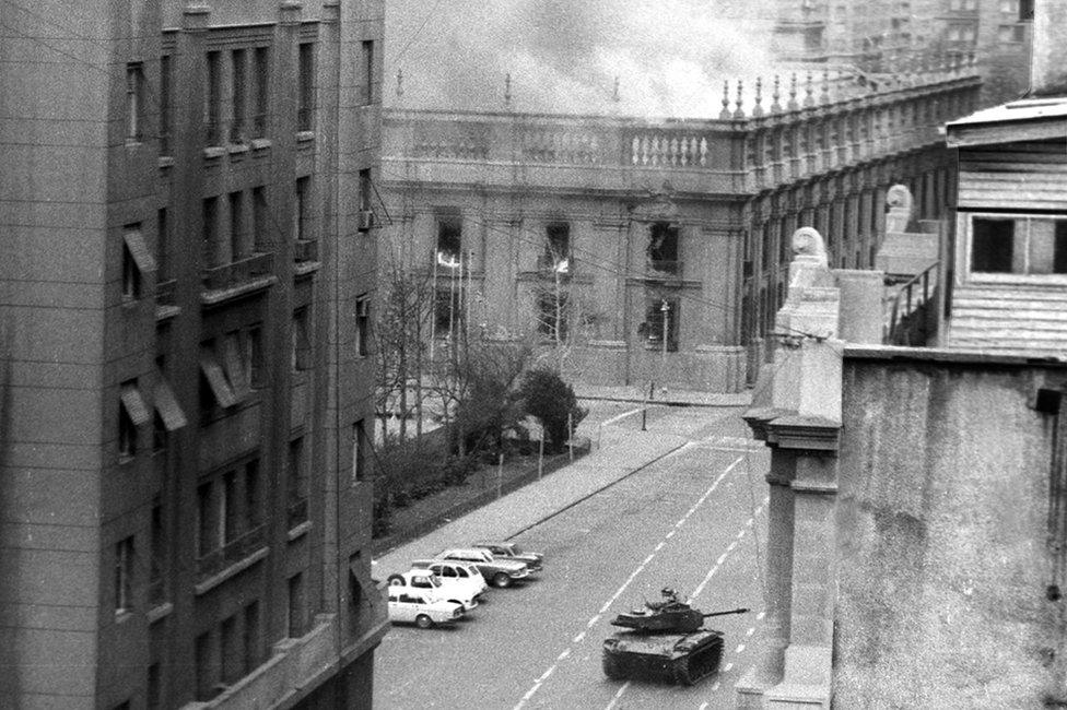 After being bombed and rocketed by the Chilean Air Force planes, La Moneda burns. Photographed during the aftermath of the coup d'etat led by Commander of the Army General Augusto Pinochet. (Photo by Horacio Villalobos/Corbis via Getty Images)