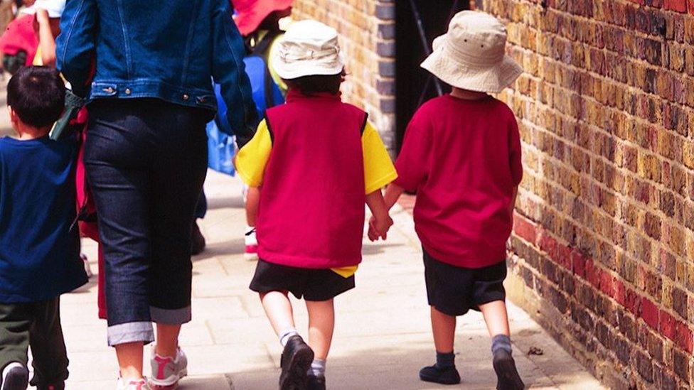 Children and parent walking to school