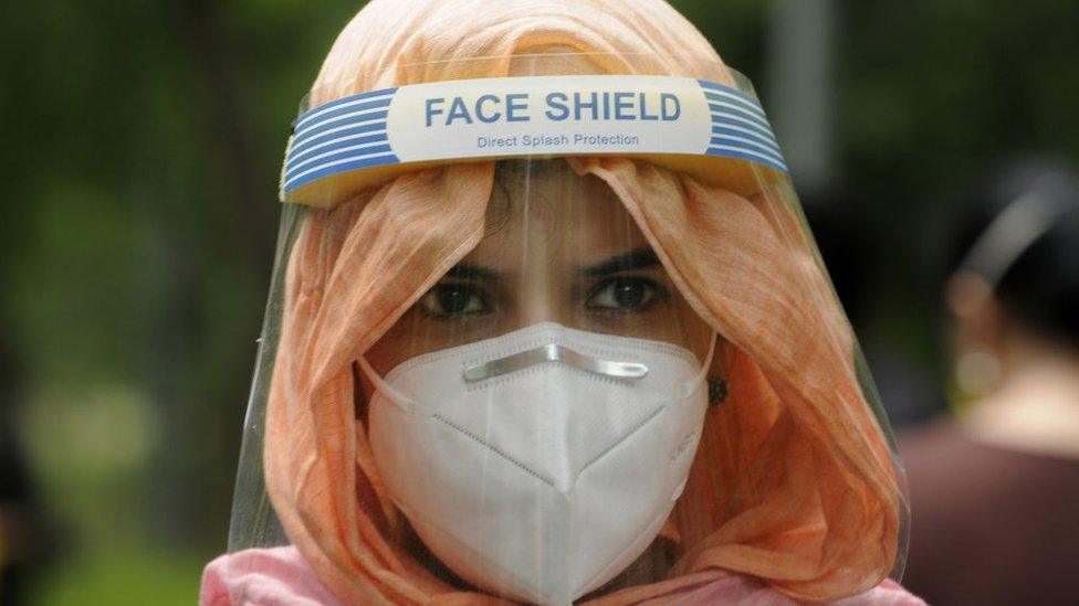 A student wears a face shield while appearing for a B.Ed entrance exam.