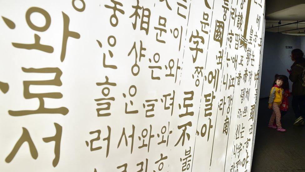 A girl looking at Hangul, Korea's phonetic alphabet.